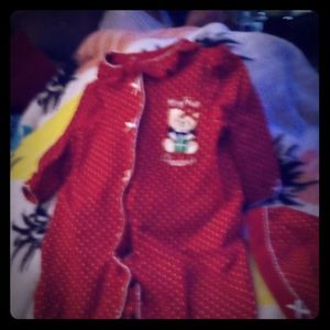 A baby a sleeper it has red with white spots littl